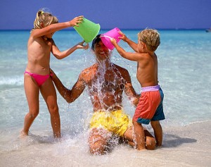 Dad on beach holiday with children