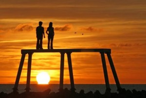 Couple watching sunset at Newbiggin on Sea